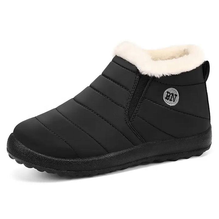 Black quilted slip-on winter boots with cozy faux fur lining and elasticated side panels, featuring a visible &