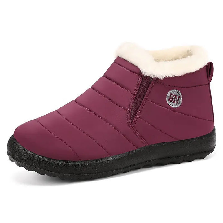 Kaelum burgundy quilted water-resistant slip-on winter boots with plush faux fur lining and elasticated side panels, shown from the front on a white studio background.