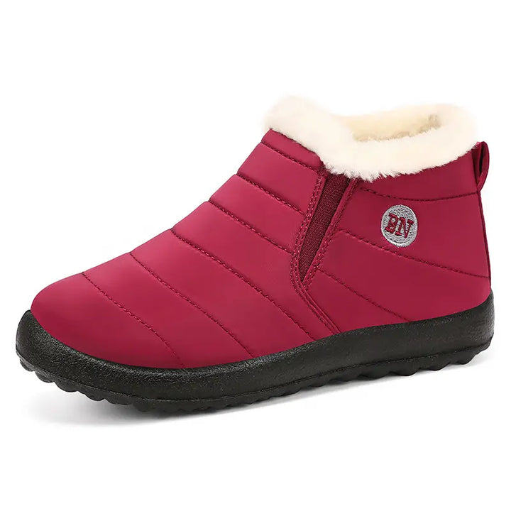 Kaelum unisex ankle winter boots in deep red, featuring a quilted water-resistant upper, plush grey faux fur lining, and a durable slip-on design with elasticated side panels.