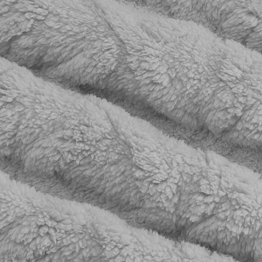 Close-up view of the soft, textured, high-pile fleece fabric in a light grey color, showcasing the distinct chevron pattern and plush feel of the Kaelum hoodie.