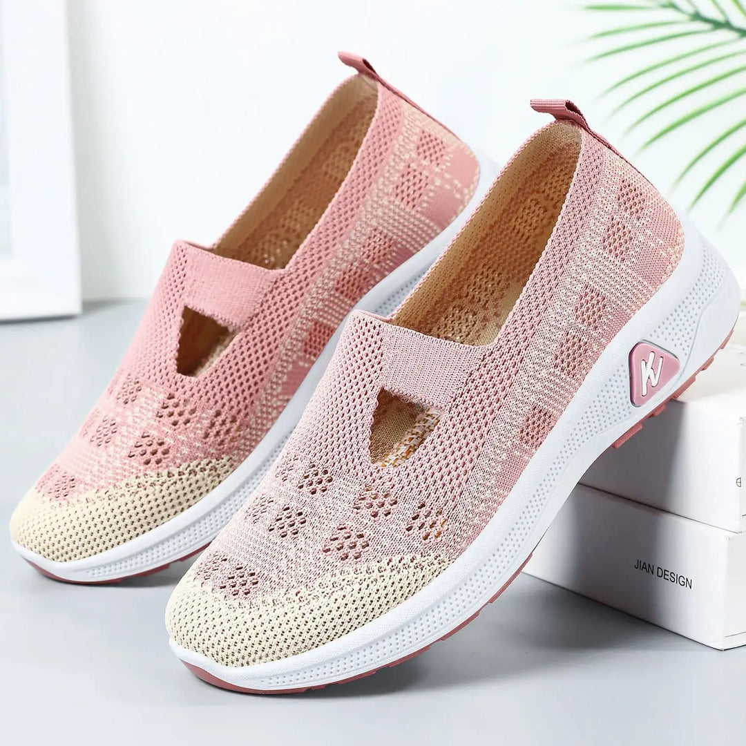 Lilac purple breathable mesh slip-on sneakers with a geometric knit pattern, keyhole instep cut-out, white sculpted sole, and a pink &