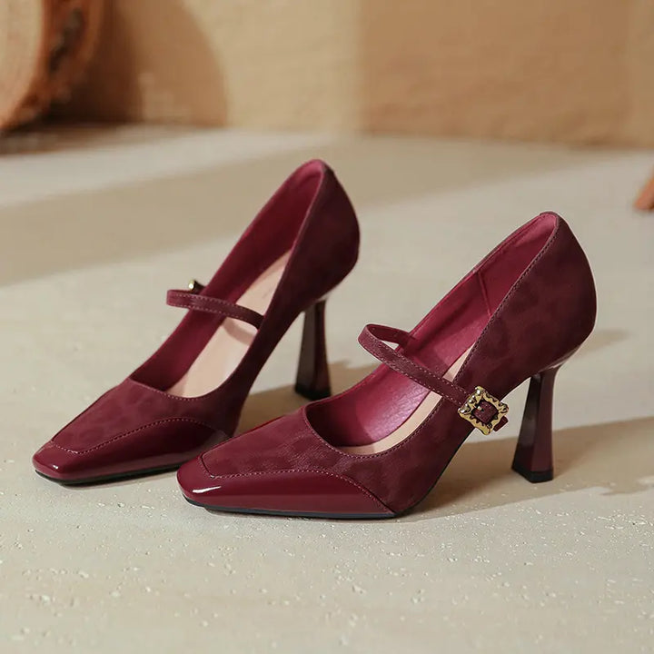 Kaelum patent leather Mary Jane heels in wine red, featuring a square toe, textured suede panels, and a decorative gold-tone buckle on the instep strap.