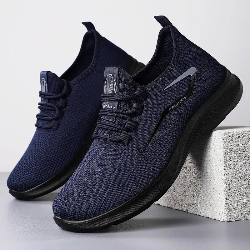 Three-quarter front view of navy blue engineered knit men&