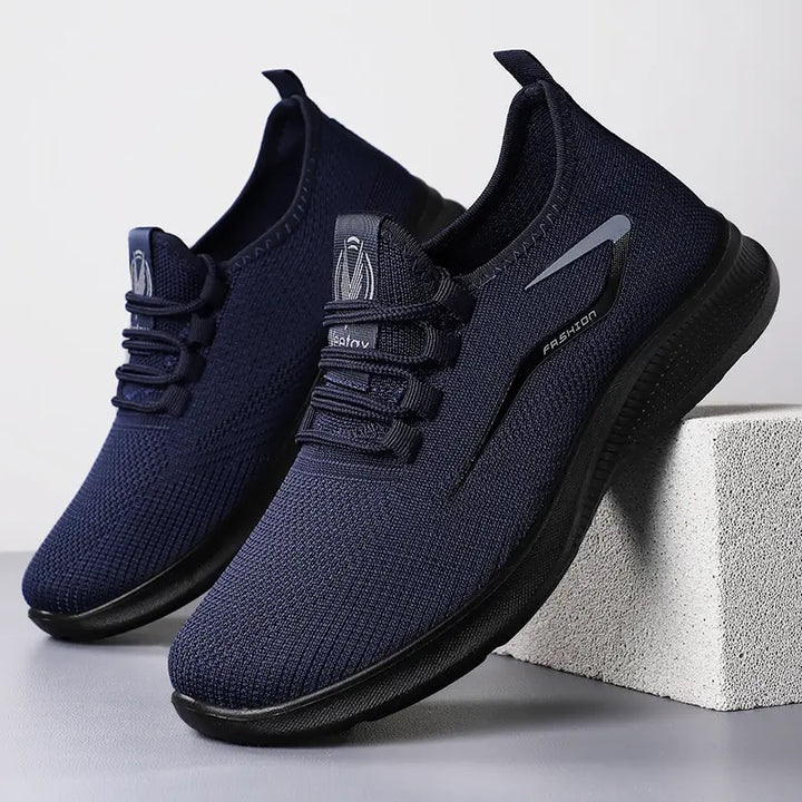 Three-quarter front view of navy blue engineered knit men&