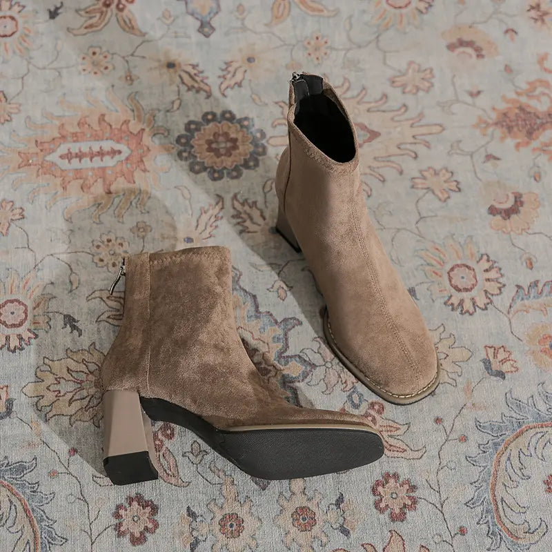 Chic suede-like ankle boots in warm khaki featuring a square toe, back zipper, and a stable 4-5cm block heel, presented on a decorative rug.