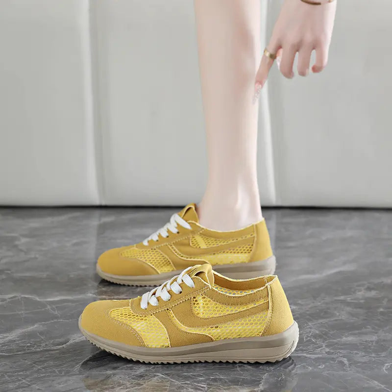 Khyzra yellow breathable mesh trainers with suede-like accents, shown on a person&