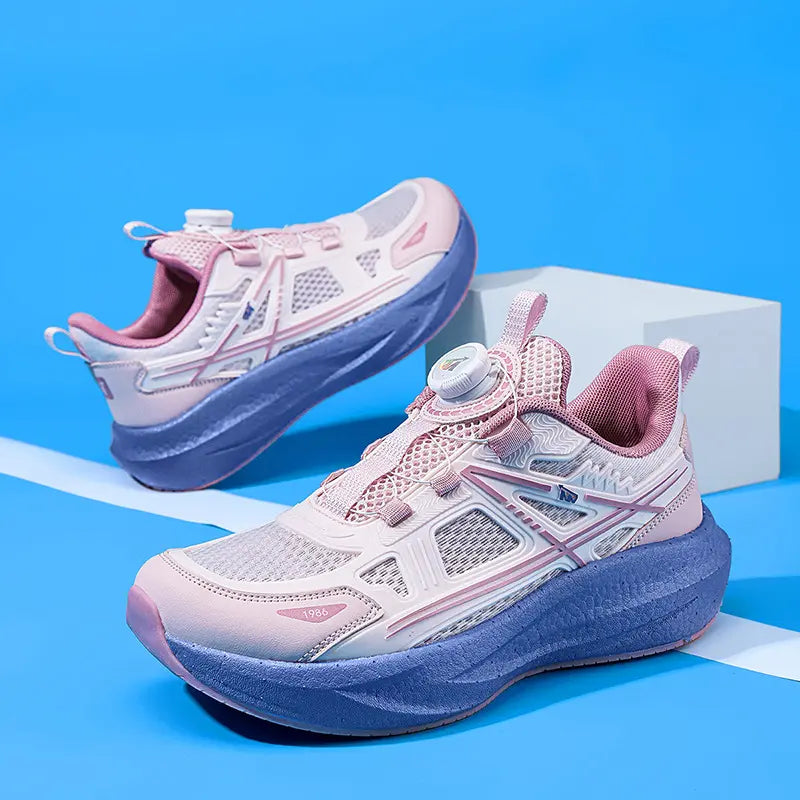 Vibrant pink and purple children's breathable running shoes with a dial closure system, mesh upper, and chunky sculpted sole, shown from a three-quarter angle on a studio background.