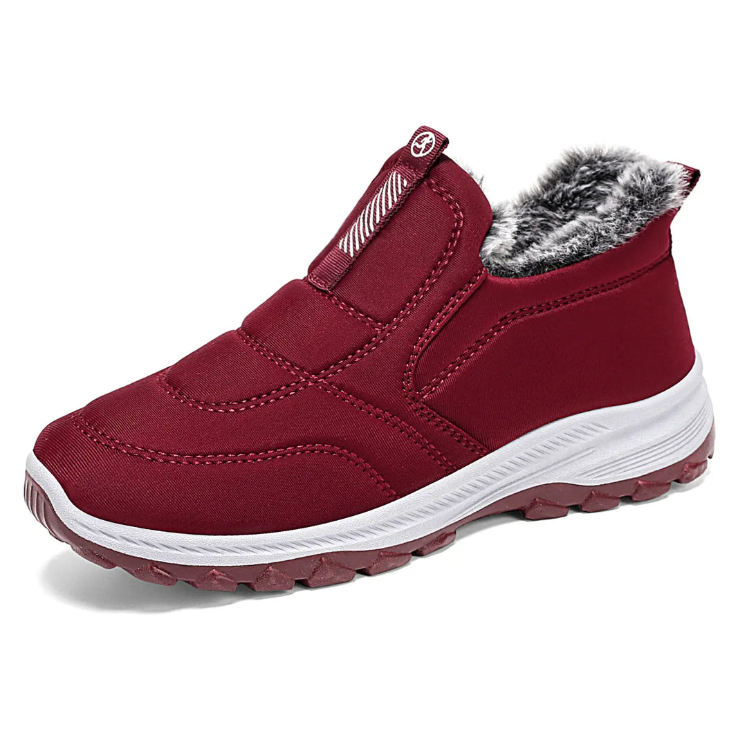 A single, deep matte red quilted Lycra slip-on winter boot with a fluffy greyish-white faux fur lining and a layered white and dark red textured sole, shown from a three-quarter side view on a white background.