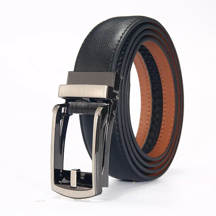 Korvan men's black leather belt with a gunmetal automatic buckle, coiled to showcase the tan leather lining and embossed texture.