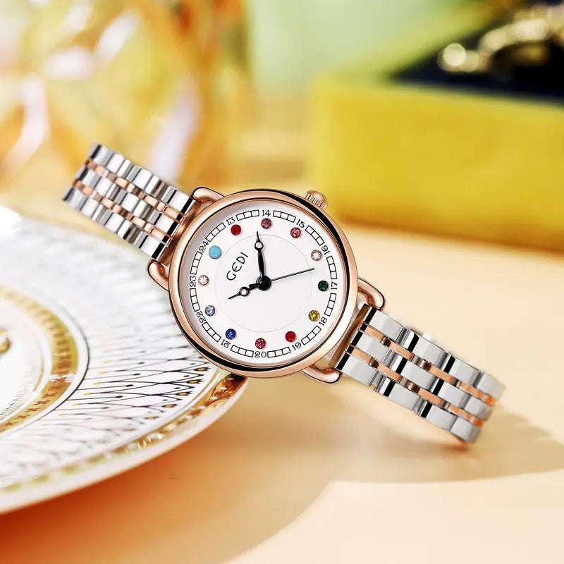 Kovian women's steel bracelet watch featuring a 26mm round case, white analog dial with colourful gemstone hour markers, and a two-tone silver and rose gold multi-link bracelet.