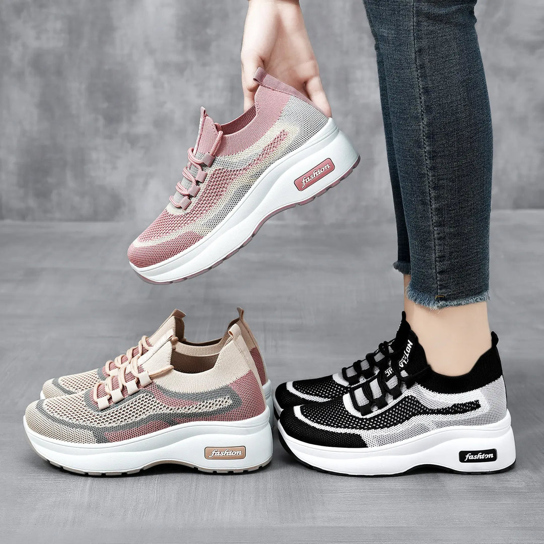 Three Krylos chunky platform trainers in blush pink, beige, and black, showcasing engineered knit uppers and white layered soles, with one pair held for a three-quarter view.