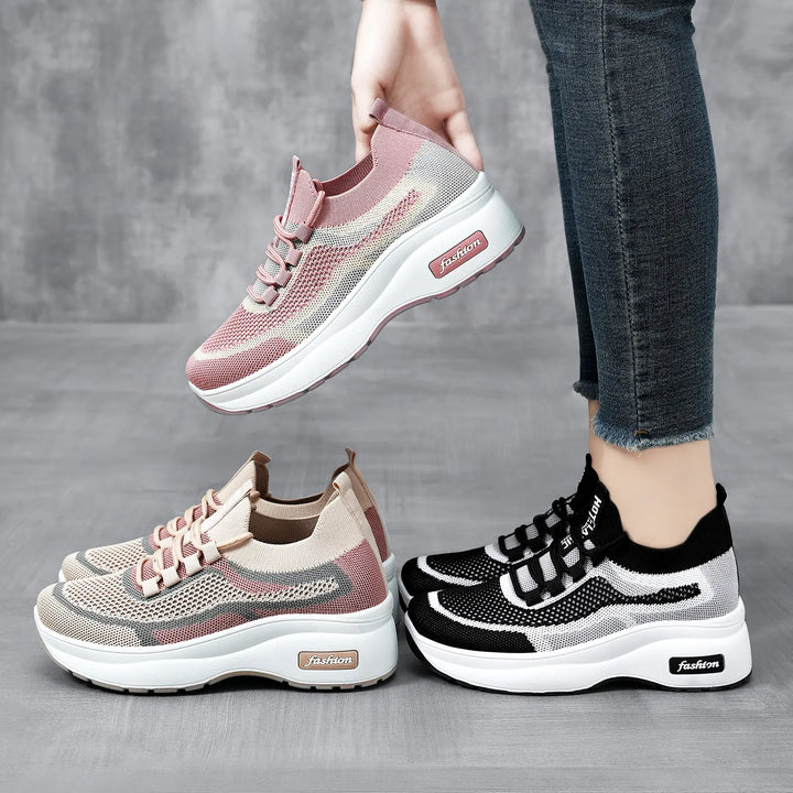 Three Krylos chunky platform trainers in blush pink, beige, and black, showcasing engineered knit uppers and white layered soles, with one pair held for a three-quarter view.