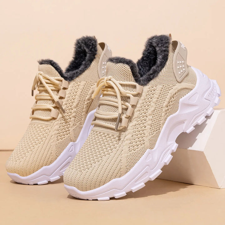 Kryptik beige knit ankle boots with plush faux fur lining and a chunky white platform sole, presented in a studio setting from a front view.