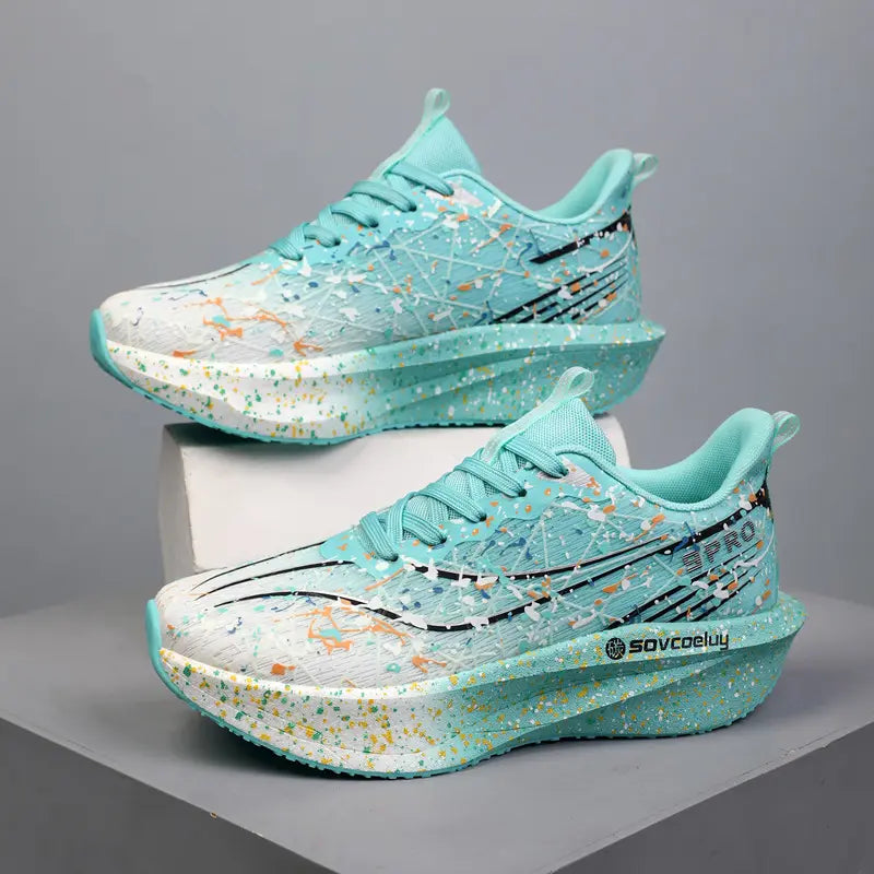 Light aqua Krytox performance running shoes with vibrant paint splash pattern and sculpted speckled midsole, shown in a three-quarter view.