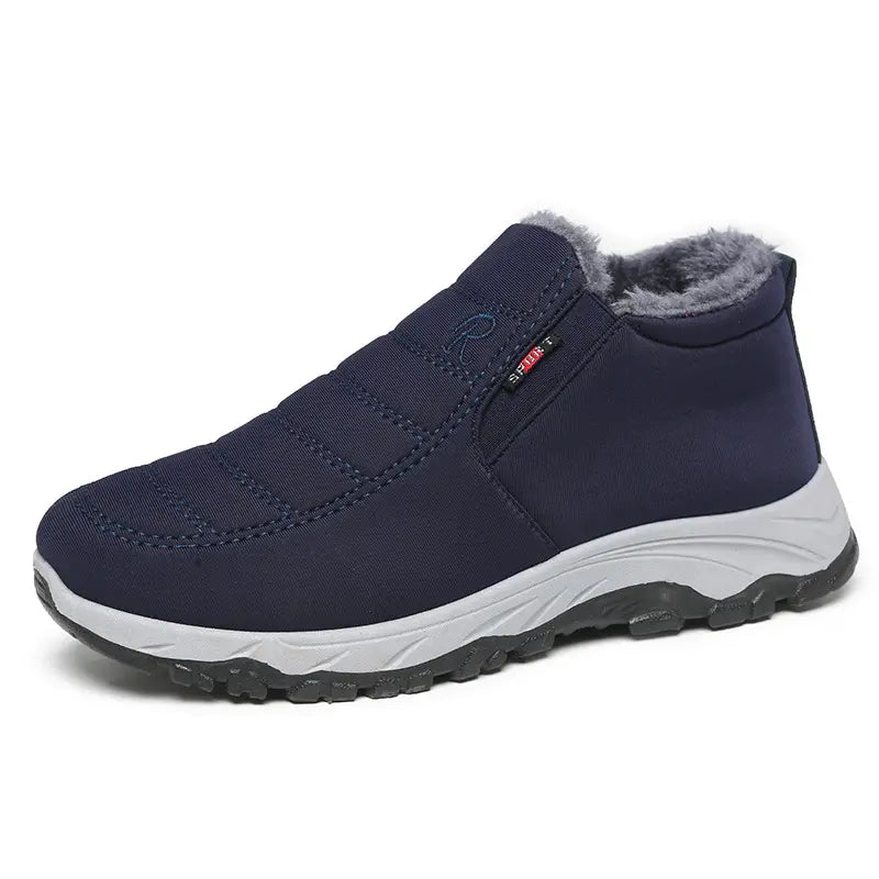 Kryvax men's navy blue quilted synthetic winter boots with grey faux fur lining, slip-on design, and contrast treaded sole, shown from a three-quarter angle.