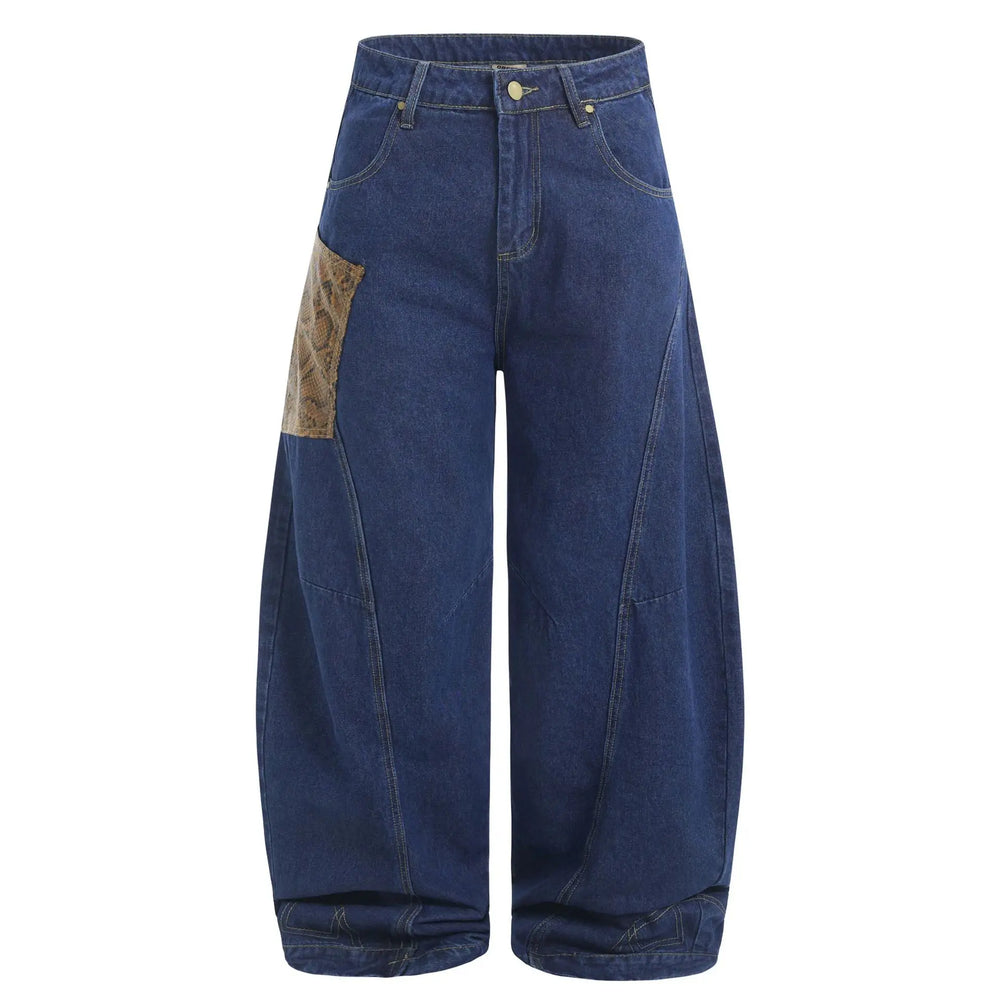 Kylath dark wash wide leg jeans featuring a distinctive faux-snakeskin panel on the upper left thigh and tonal stitching, shown in a front studio view.