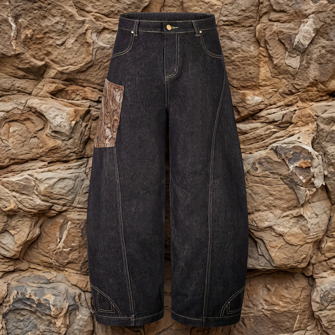 Front view of Kylath wide leg jeans in dark wash denim, featuring a distinctive snake print panel on the thigh and a floor-length silhouette.