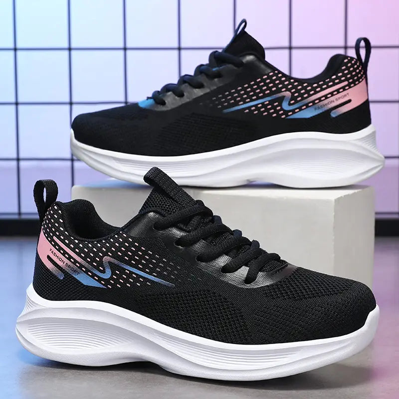 Two black Kylos women's breathable running shoes displayed from a three-quarter view, featuring a pink and teal gradient graphic and white 'FASHION SPORT' text on the side.
