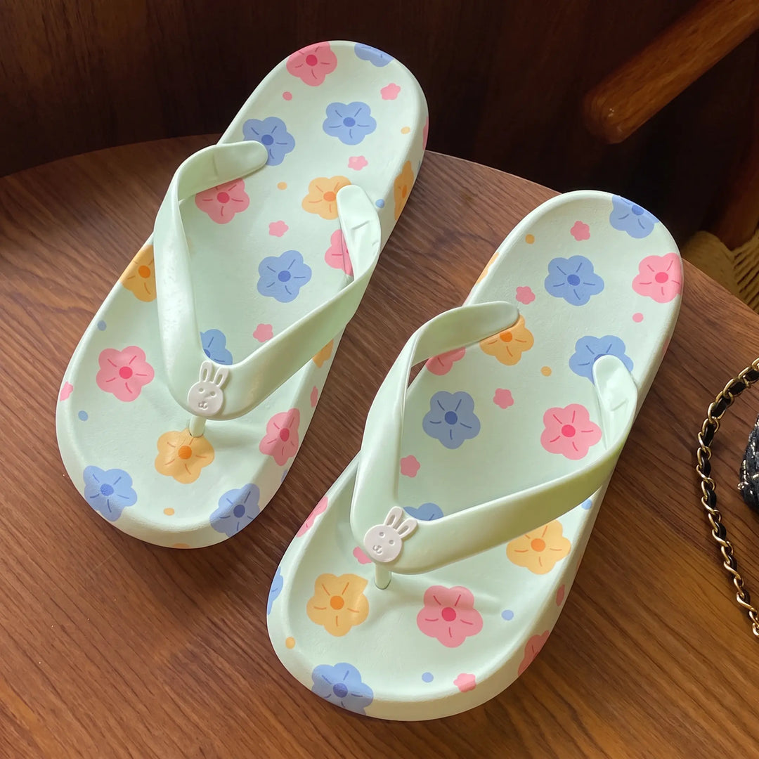 Kythor floral platform flip-flops in pastel green with a cute bunny charm and cheerful flower print on the footbed.