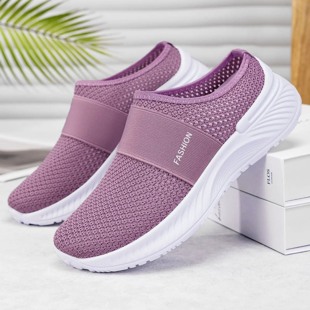 Dusty lavender breathable mesh slip-on sneakers for women, featuring a white sole and an elasticated band across the instep with white &