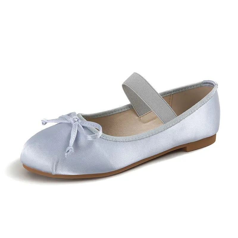 Light blue satin ballet flat with a delicate fabric bow on the toe and a grey elastic instep strap, shown from a side angle on a white background.