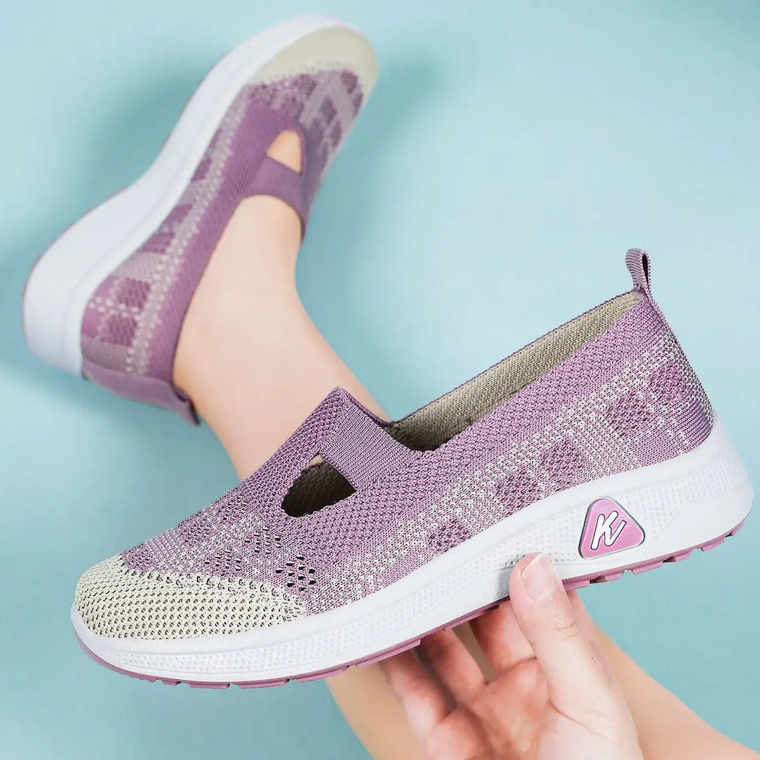 Lilac purple breathable mesh slip-on sneakers with a geometric knit pattern and a keyhole instep cut-out, viewed from a three-quarter angle.