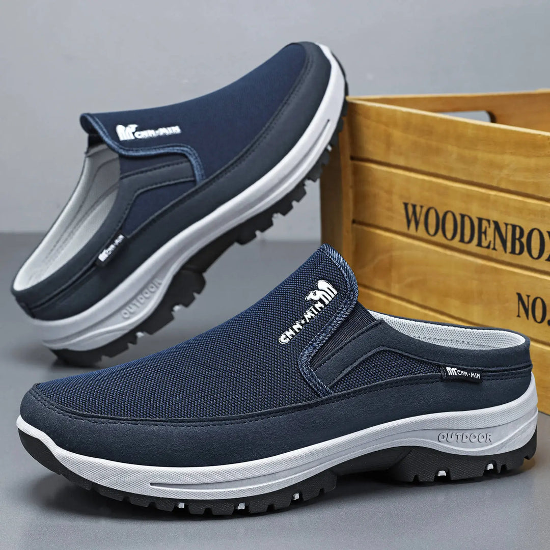 Dark blue men's breathable mesh slip-on mule shoes with a rounded toe and open heel, detailed with a white midsole and black rubber outsole featuring 'OUTDOOR' lettering.