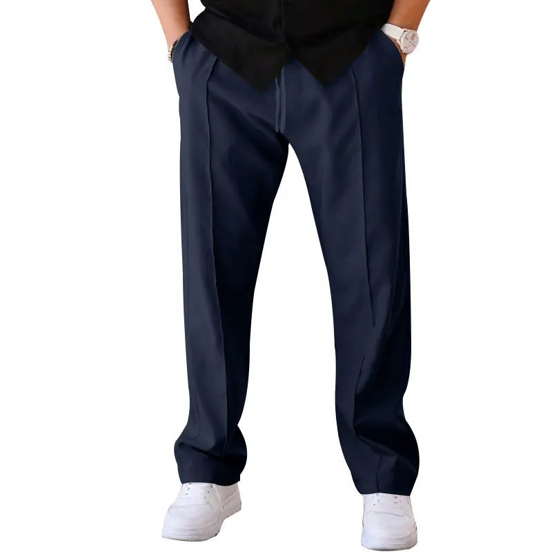 Men's navy blue relaxed fit trousers in waffle knit fabric, featuring a central front crease and drawstring waist. Presented in a studio shot from the front view.