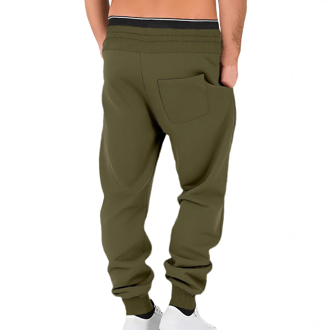 Back view of men's olive green fleece-lined joggers with tapered legs, ribbed cuffs, and a rear patch pocket.