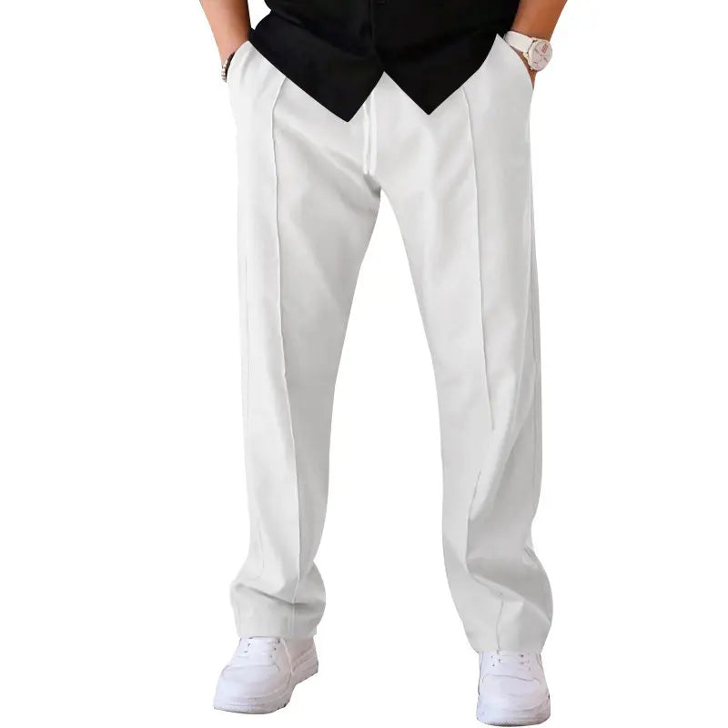 Men's white relaxed fit casual trousers in waffle knit fabric, featuring a front crease, drawstring waist, and side pockets, shown from a front view on a white background.
