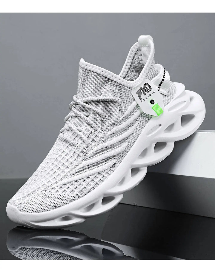 Three-quarter view of a modern warm beige and grey engineered knit high-top sneaker with a sculpted light tan sole, featuring a lime green tag and a white FKO COM-MIH label.