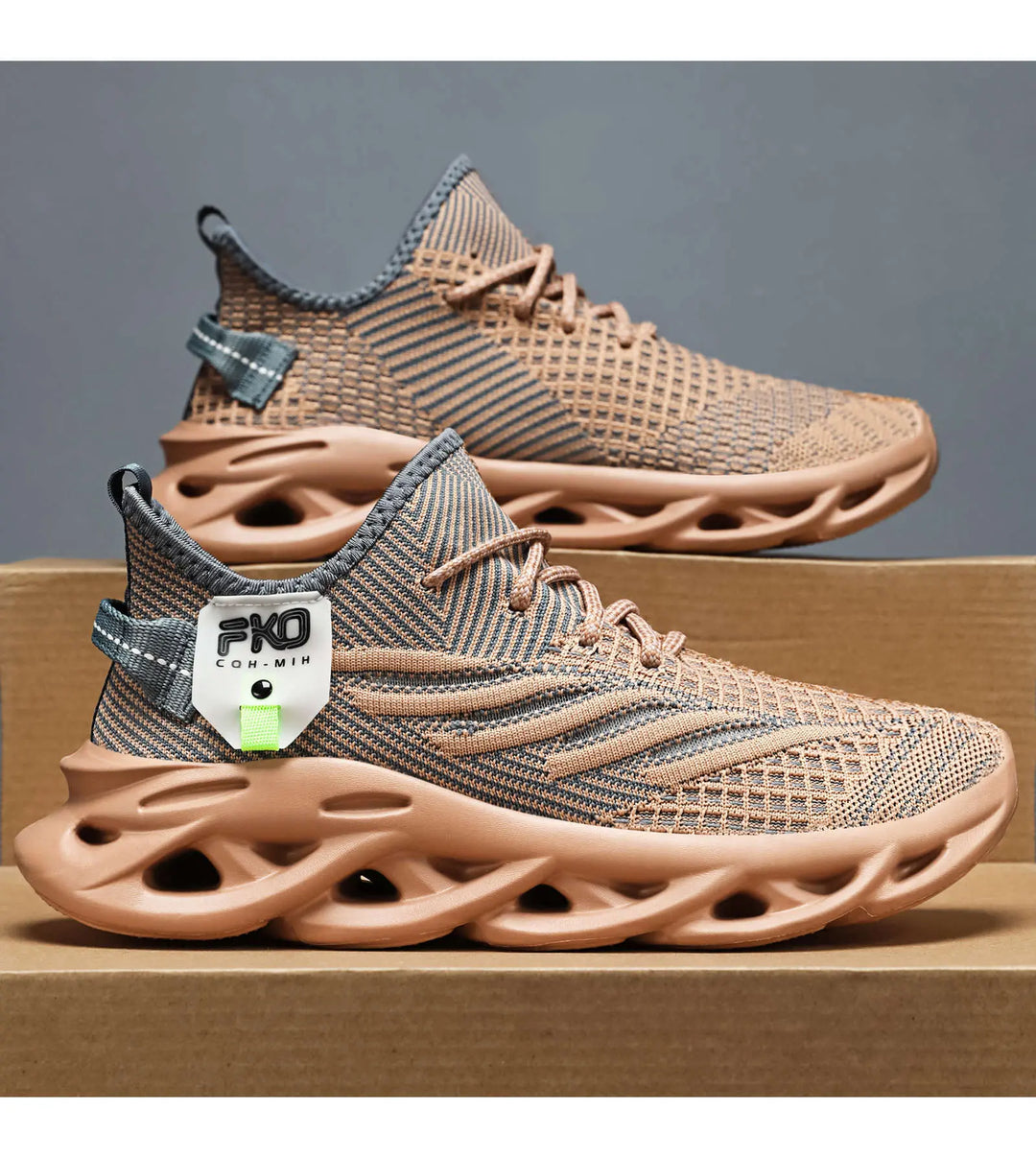 Mikari unisex high-top athletic sneakers in earthy taupe knit with grey line pattern, featuring a sculpted light tan sole, navy heel tab, and a lime green branded tag.