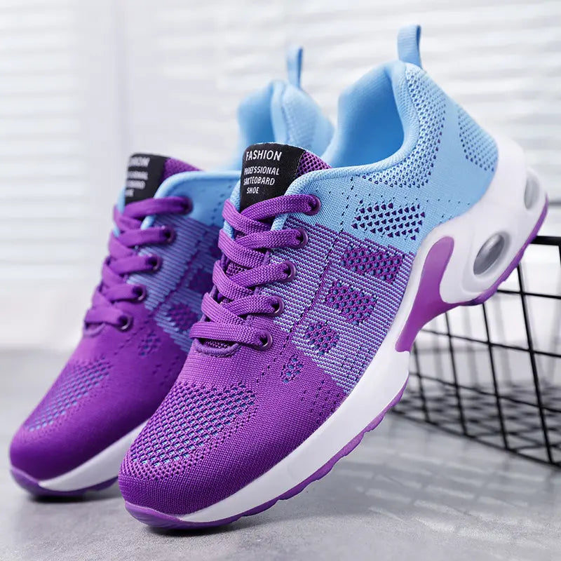 Women's Nivila running trainers featuring a breathable purple to sky blue gradient mesh upper, lace-up closure, and a white midsole with visible air cushioning.