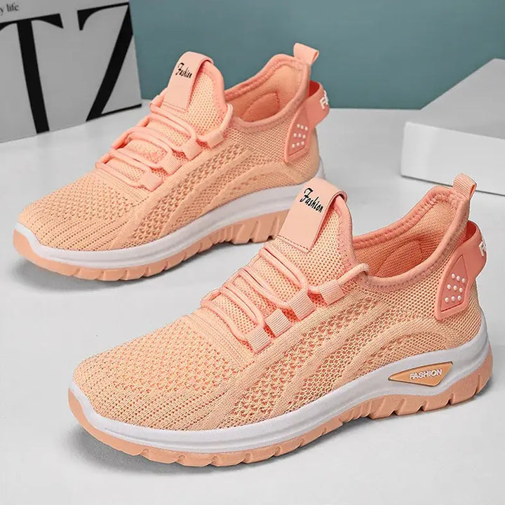 Oat beige breathable mesh sneakers for women, shown in a three-quarter view on a studio background. These casual athletic trainers feature a white sole with grey &