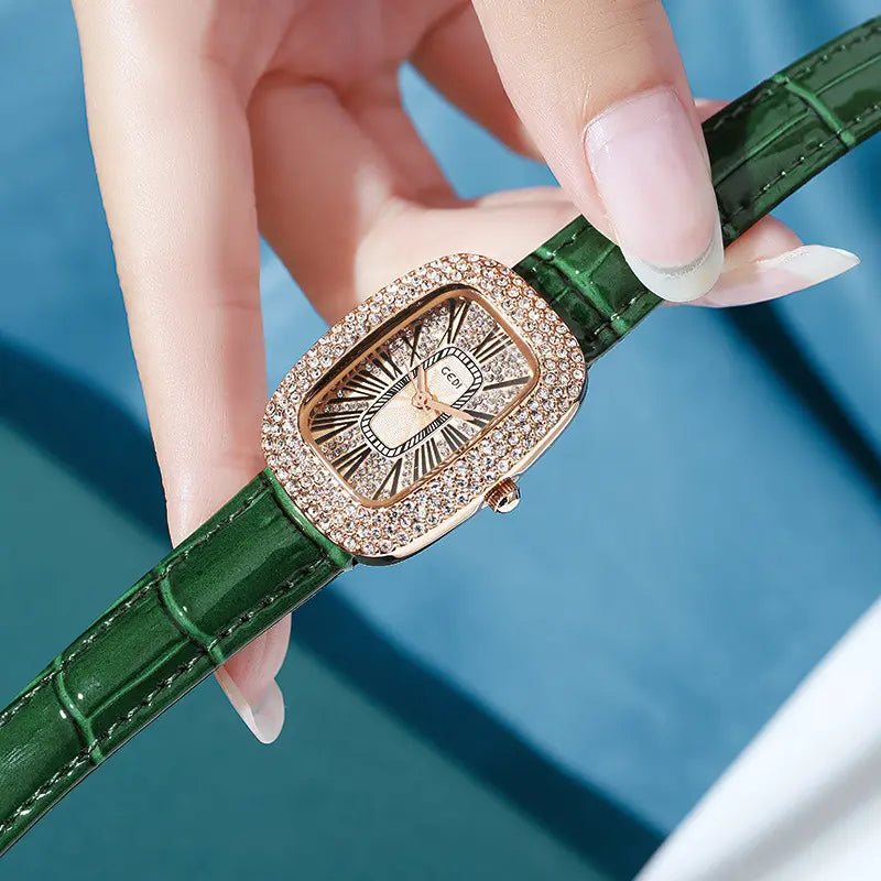 Elegant oval watch with a rose gold-toned case fully encrusted with shimmering crystals and a green alligator-embossed leather strap.