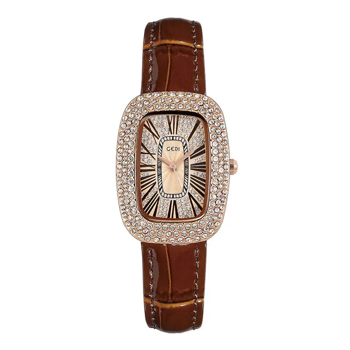 Elegant oval rose gold-toned watch with a crystal-embellished bezel, champagne sunburst dial featuring black Roman numerals, and a glossy brown alligator-embossed leather strap. The watch features slim rose gold hands and a polished silver-toned pin buckle.