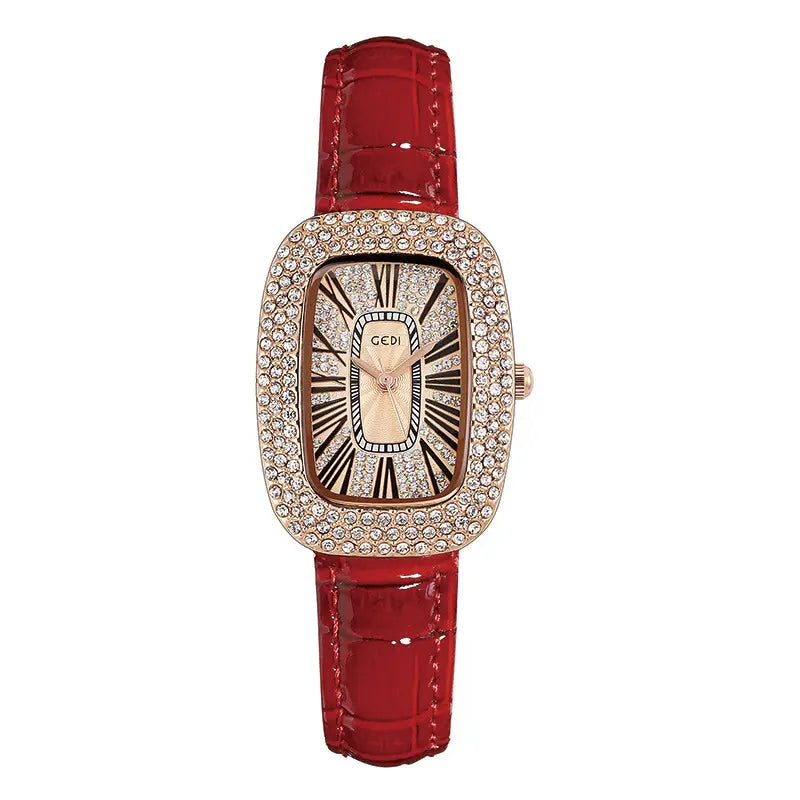 Elegant oval rose gold watch with a sparkling crystal-embellished bezel, a champagne sunburst dial featuring Roman numerals, and a glossy red alligator-embossed genuine leather strap.