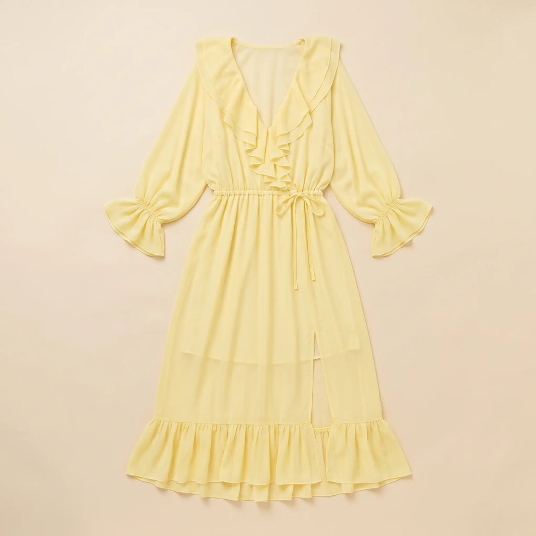 Pale yellow chiffon midi dress with cascading ruffles on the V-neck, voluminous long sleeves, and tiered hem, featuring a drawstring waist and side slit.