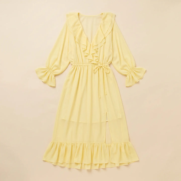 Pale yellow chiffon midi dress with cascading ruffles on the V-neck, voluminous long sleeves, and tiered hem, featuring a drawstring waist and side slit.