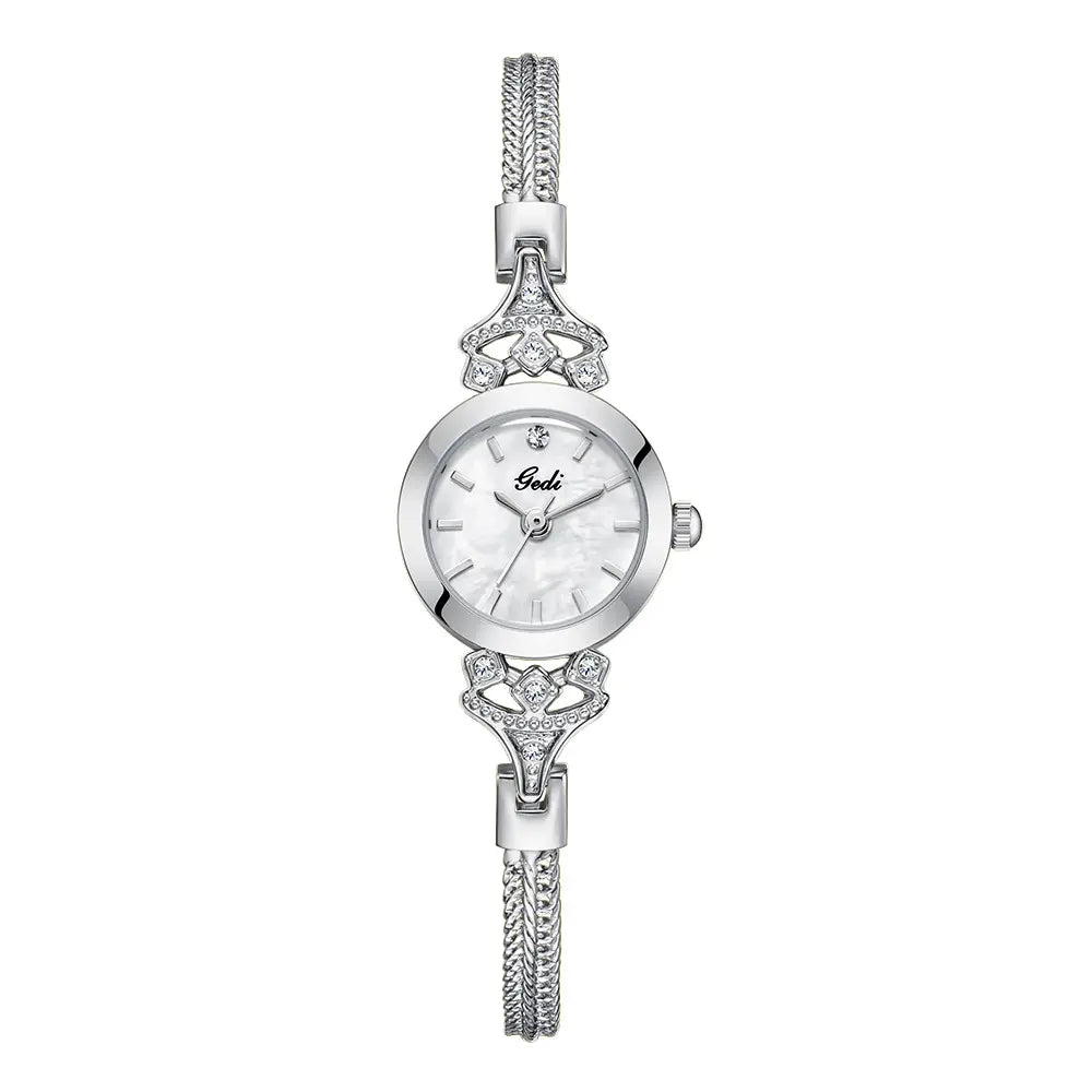 Elegant petite silver-tone alloy bracelet watch featuring a blue mother-of-pearl dial with subtle iridescent patterns and sparkling crystal embellishments on the lugs and bracelet.