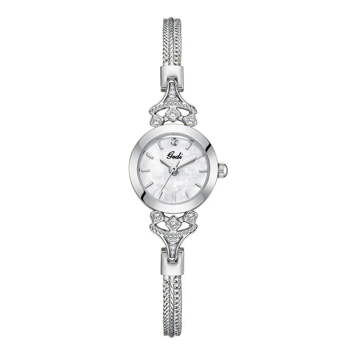 Elegant petite silver-tone alloy bracelet watch featuring a blue mother-of-pearl dial with subtle iridescent patterns and sparkling crystal embellishments on the lugs and bracelet.