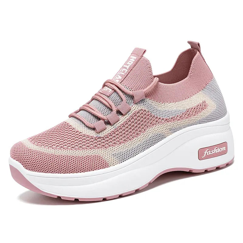 Pink and grey striped knit platform trainers with a chunky white sole and grey lace-up closure, viewed from a three-quarter angle. Features a sock-like ankle collar and &