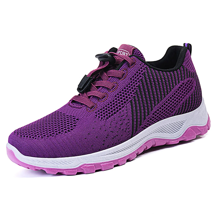 Purple lightweight walking trainers featuring a breathable knitted mesh upper and a quick-lace toggle system, shown in a three-quarter view.