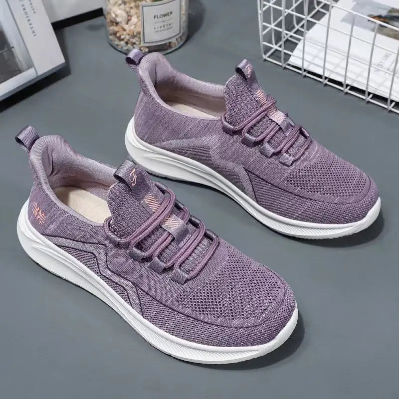 Pair of dusty lilac purple breathable mesh athletic trainers with white sculpted soles and wavy side detail.