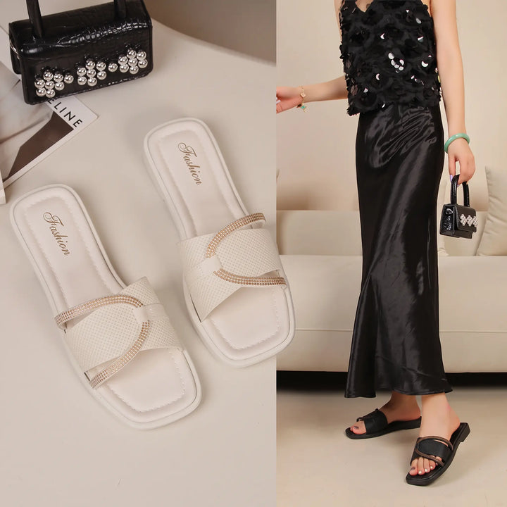Pair of white Qyrell chic flat sandals with square toes and embellished straps, shown alongside a lifestyle image of black sandals worn by a model.