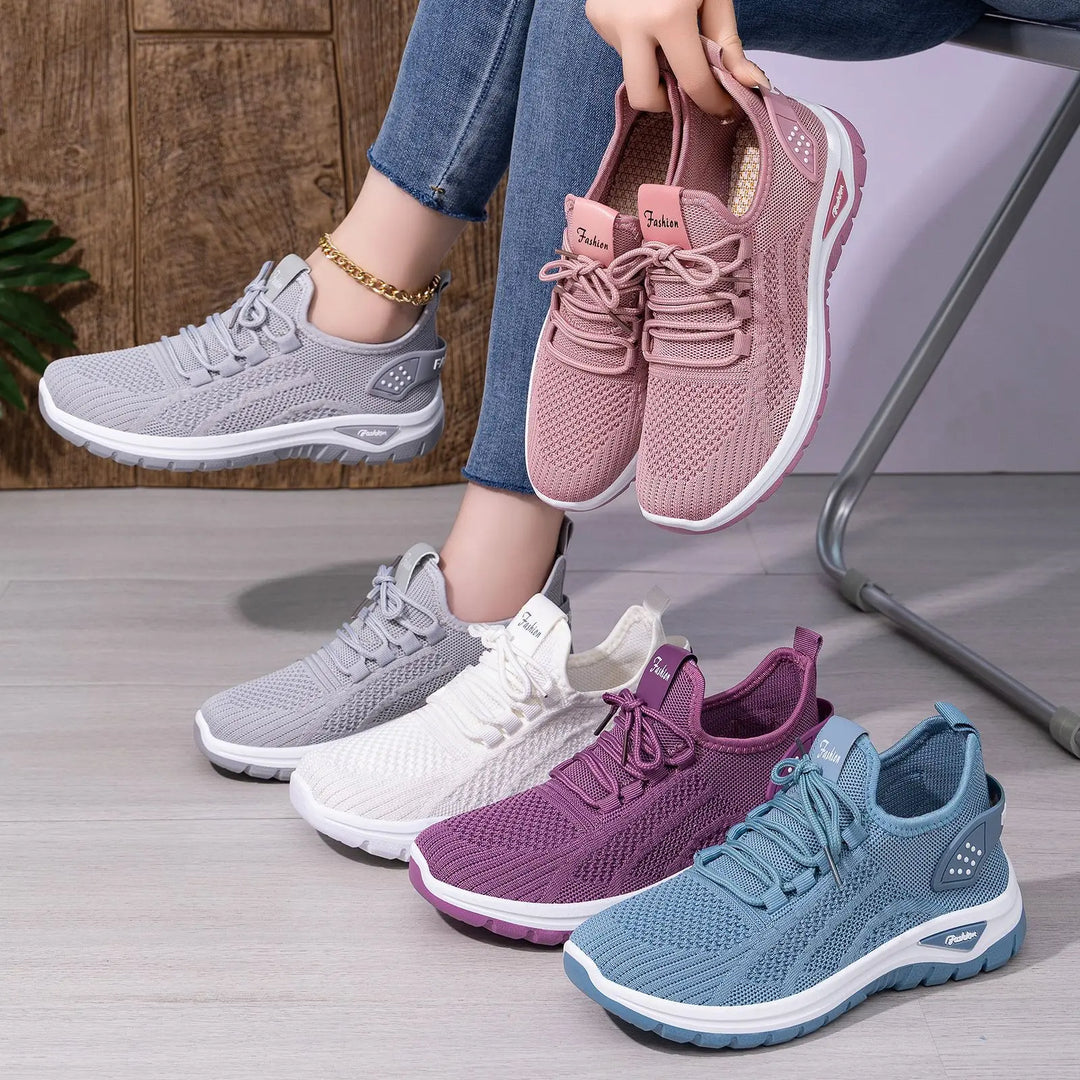 Oat beige and pastel multi-colored Raxen breathable mesh sneakers displayed in a lifestyle arrangement, showing multiple pairs and angles with a person holding a pink pair.