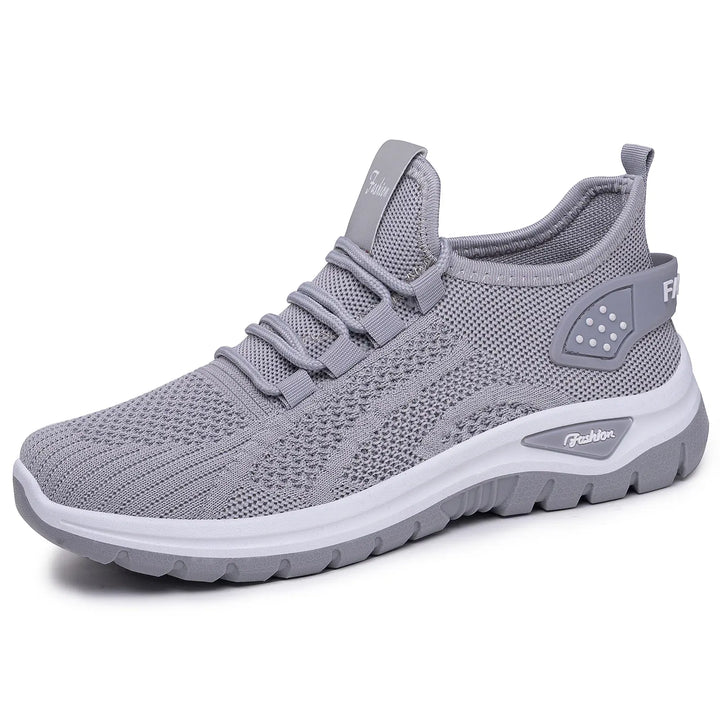 Grey Raxen breathable mesh sneakers in a front-three-quarter view, showcasing their lightweight design, comfortable cushioning, and subtle &