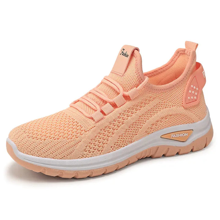Oat beige Raxen breathable mesh sneakers with a white sculpted sole and flat tonal laces. This front view showcases the lightweight comfort trainers.