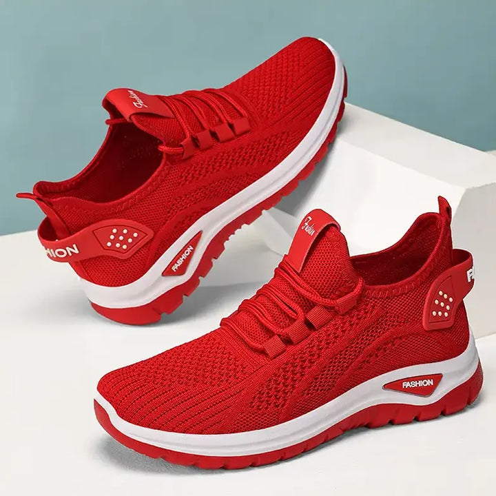 Vibrant red Raxen breathable mesh sneakers shown from a three-quarter angle, featuring a white sole with grey accent details and &