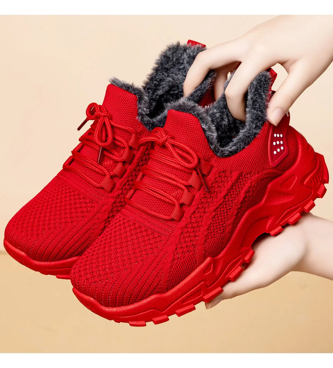 Red knit ankle boots with plush faux fur lining and a chunky platform sole, shown from a three-quarter angle.